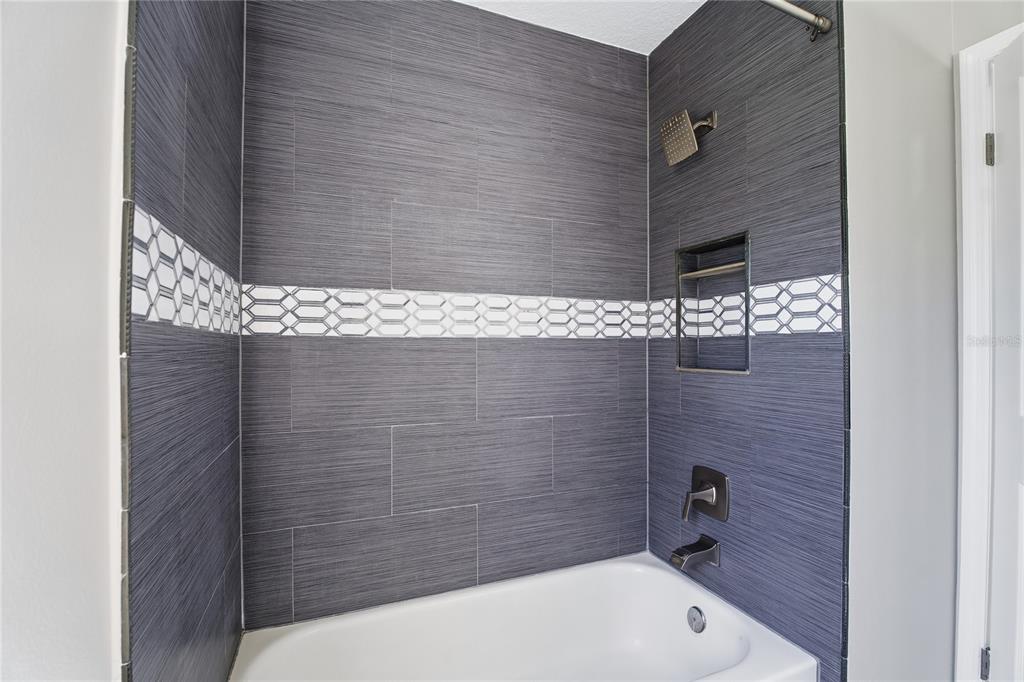 17431 Isbell Lane Odessa, FL 33556 - Photo 36 of 47 a bathroom with a sink and shower