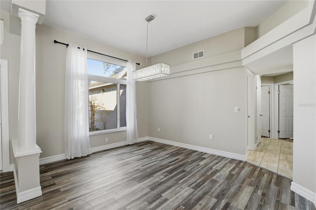 17431 Isbell Lane Odessa, FL 33556 - Photo 6 of 47 a view of an empty room with wooden floor and a window