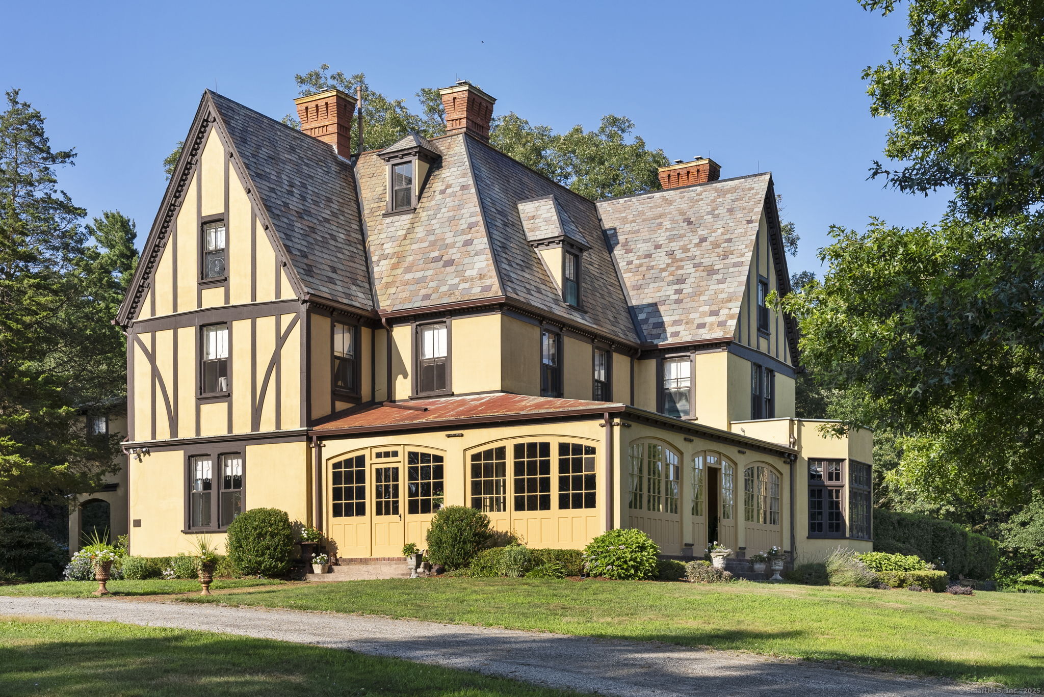 a front view of a house with a garden