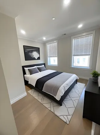 a bedroom with a bed and a desk