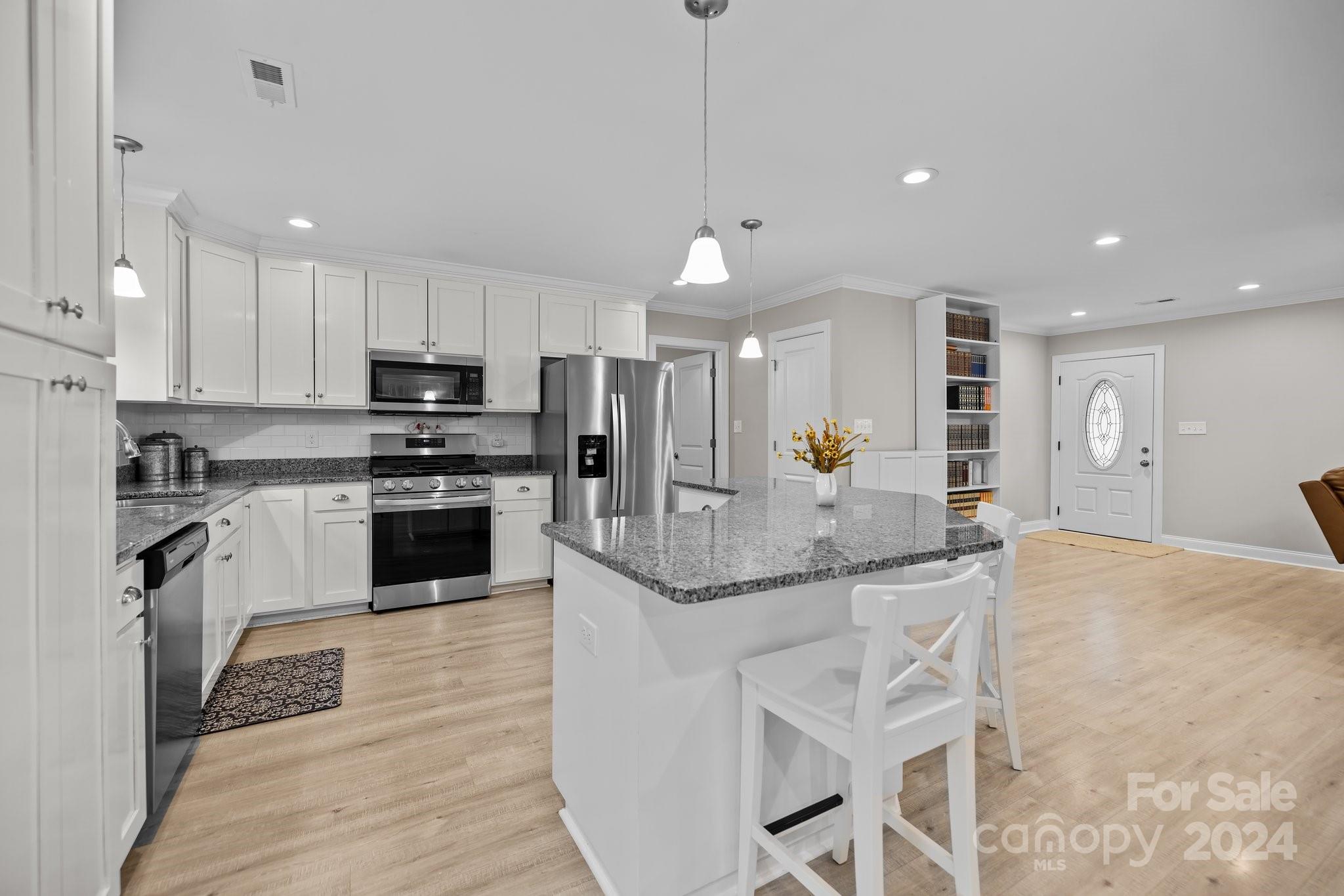 378 Boyd Faile Road Heath Springs, SC 29058 - Photo 11 of 28 a kitchen with stainless steel appliances granite countertop a stove top oven a sink and dishwasher