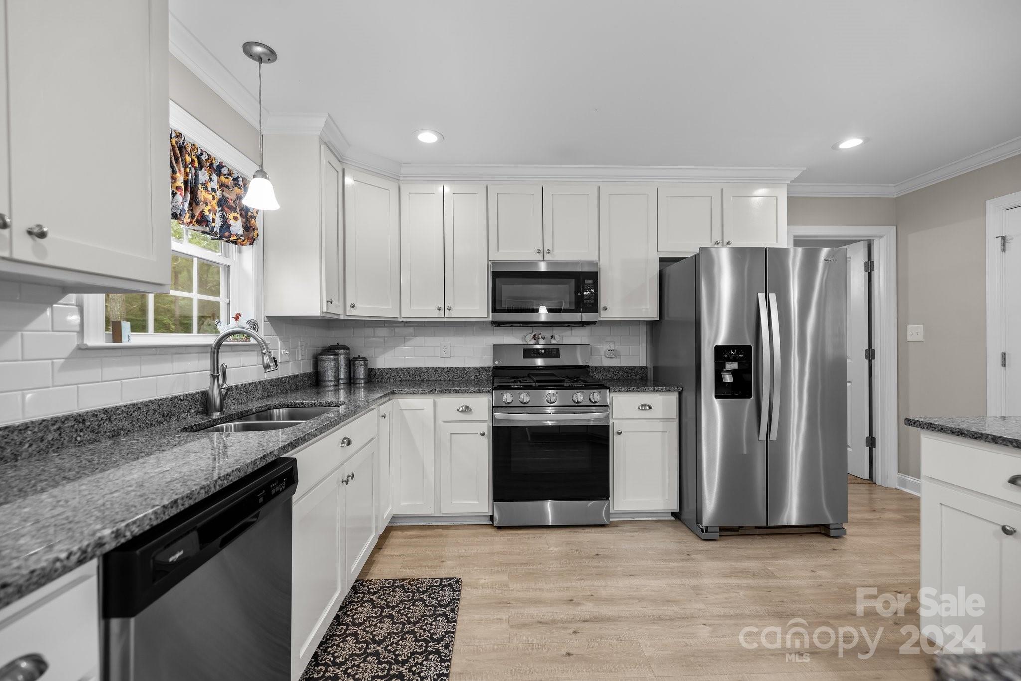 378 Boyd Faile Road Heath Springs, SC 29058 - Photo 13 of 28 a kitchen with stainless steel appliances granite countertop a stove a sink dishwasher a refrigerator and a oven