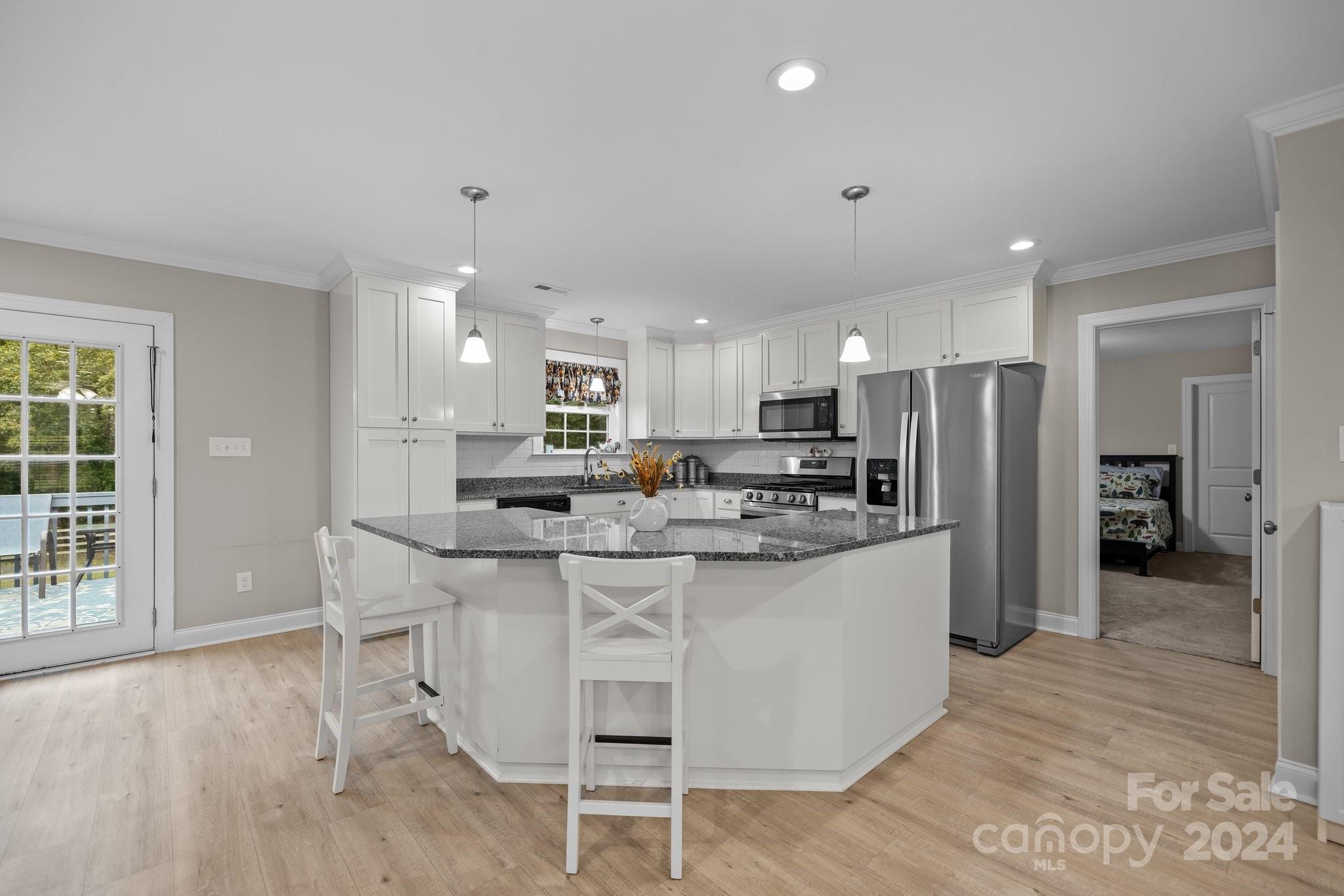 378 Boyd Faile Road Heath Springs, SC 29058 - Photo 15 of 28 a kitchen with kitchen island a sink and a refrigerator