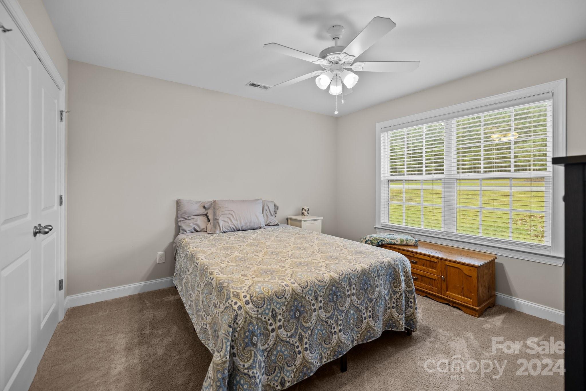 378 Boyd Faile Road Heath Springs, SC 29058 - Photo 17 of 28 a bedroom with a bed and a chandelier