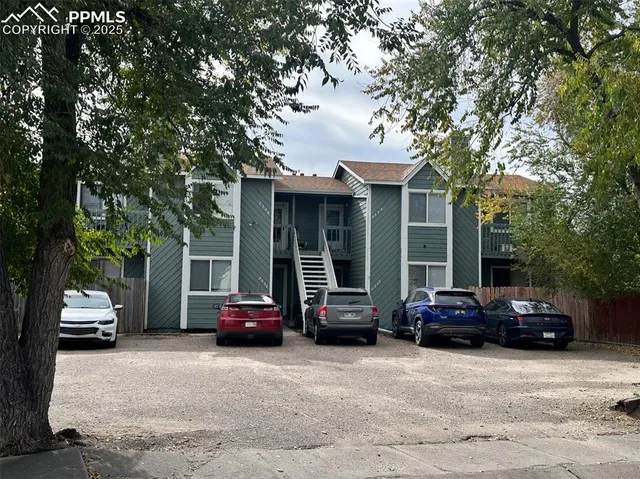 a car parked in front of house with a cars parked