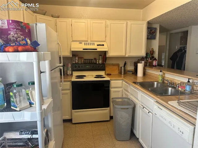 a kitchen with a table chairs sink and cabinets