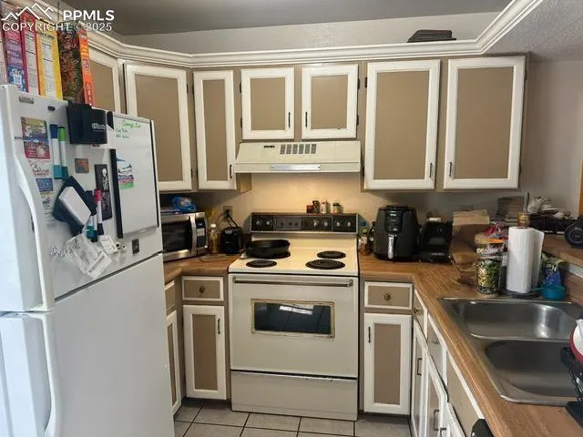 a kitchen with a stove a sink and a refrigerator