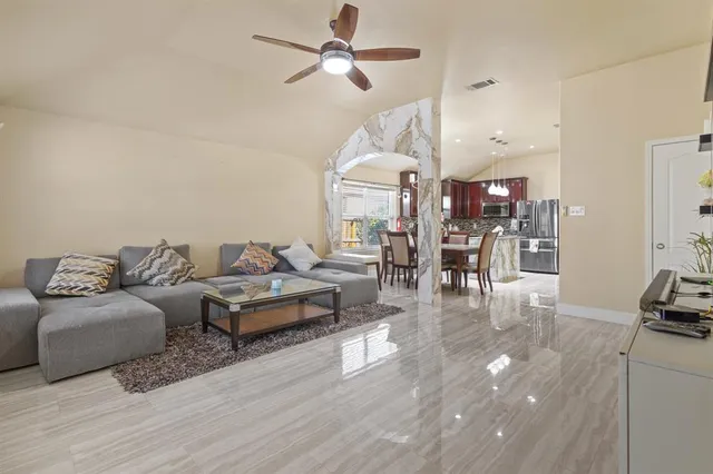 a living room with furniture and a wooden floor