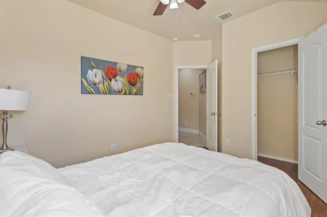 a bedroom with a bed and a painting on the wall