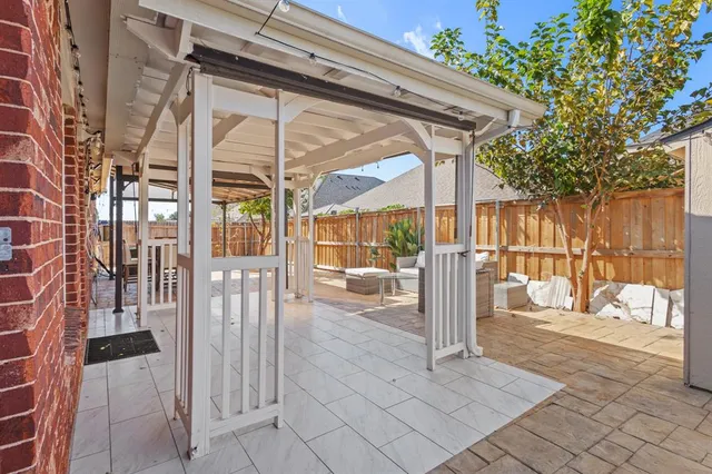a view of a porch with a floor to ceiling window with wooden fence
