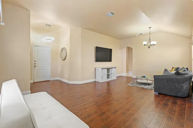 a living room with furniture and a flat screen tv