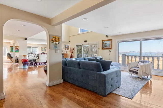 a living room with furniture a flat screen tv and a floor to ceiling window