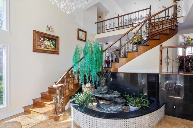 a living room with furniture large window and wooden floor