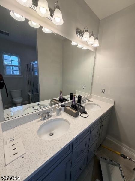101 Truman Drive Wood-Ridge, NJ 07075 - Photo 4 of 7 a bathroom with a sink a light fixture and a mirror