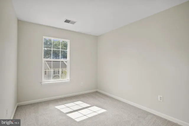 a view of an empty room and closet area