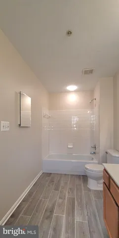 a view of kitchen with stainless steel appliances wooden floor