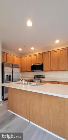 a view of kitchen with kitchen island and large window