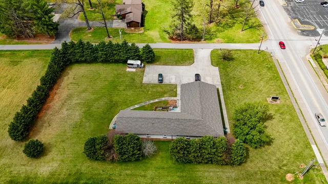 an aerial view of a house with swimming pool and outdoor space