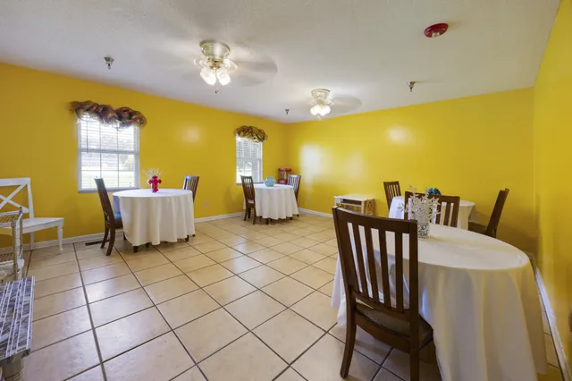 a bathroom with a granite countertop toilet and a sink