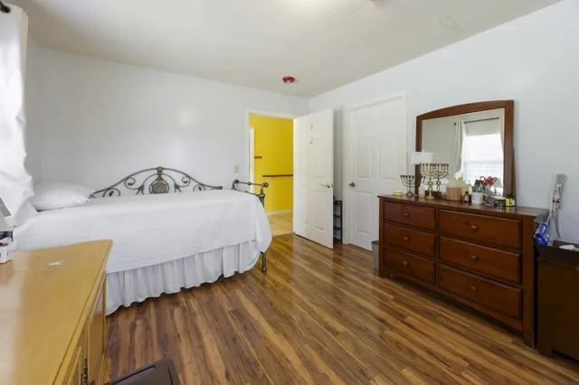 a bedroom with a bed and a window