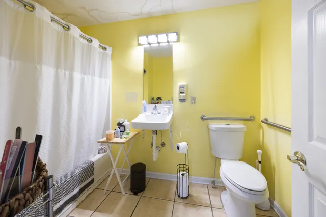 a bedroom with a bed and a chair