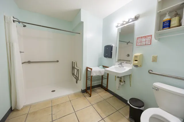 a bedroom with a bed and two lamp