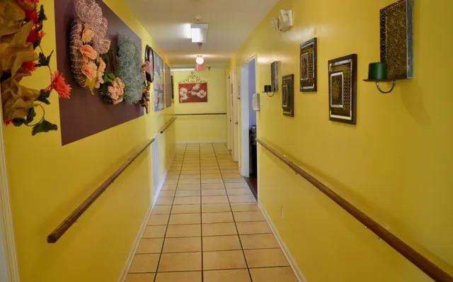 a hallway with wooden floor and staircase