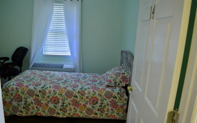 a bedroom with a bed and a window