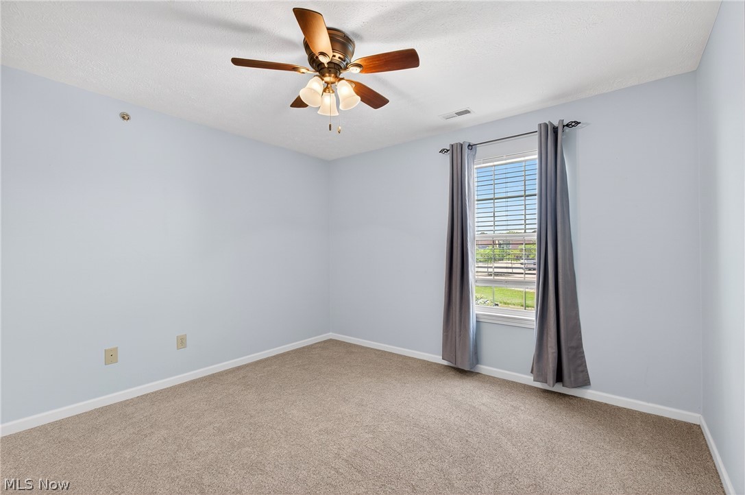 4703 Hills And Dales Road Northwest Canton, OH 44708 - Photo 16 of 25 2nd bedroom is large with natural light and ceiling fan