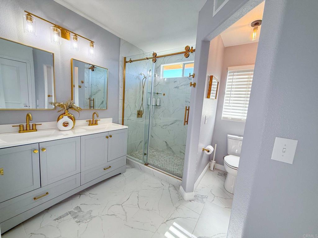 3237 Warley Road Hemet, CA 92545 - Photo 20 of 43 a spacious bathroom with a double vanity sink toilet and shower