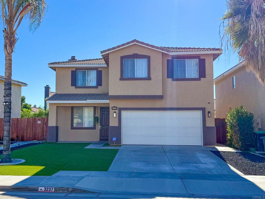 3237 Warley Road Hemet, CA 92545 - Photo 2 of 43 a front view of a house with a yard and wooden fence