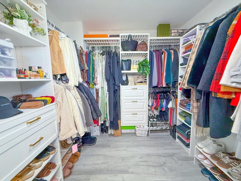 3237 Warley Road Hemet, CA 92545 - Photo 22 of 43 a view of walk in closet with clothes and shoes