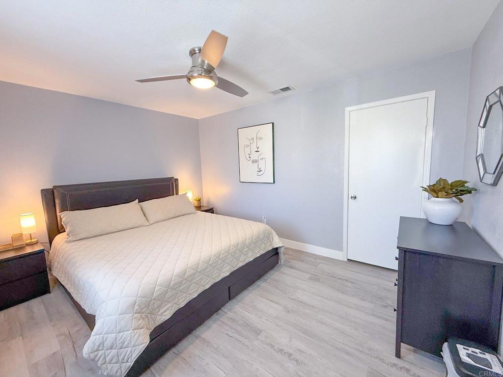 3237 Warley Road Hemet, CA 92545 - Photo 23 of 43 a bedroom with a bed and a chandelier