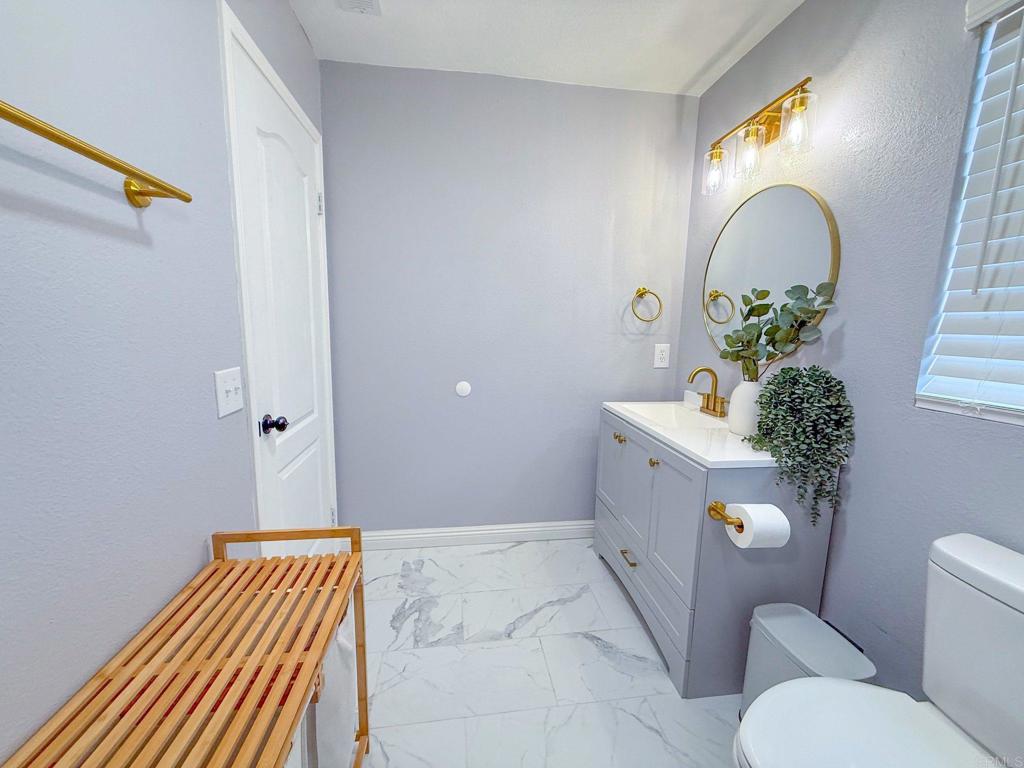 3237 Warley Road Hemet, CA 92545 - Photo 26 of 43 a bathroom with a sink and mirror