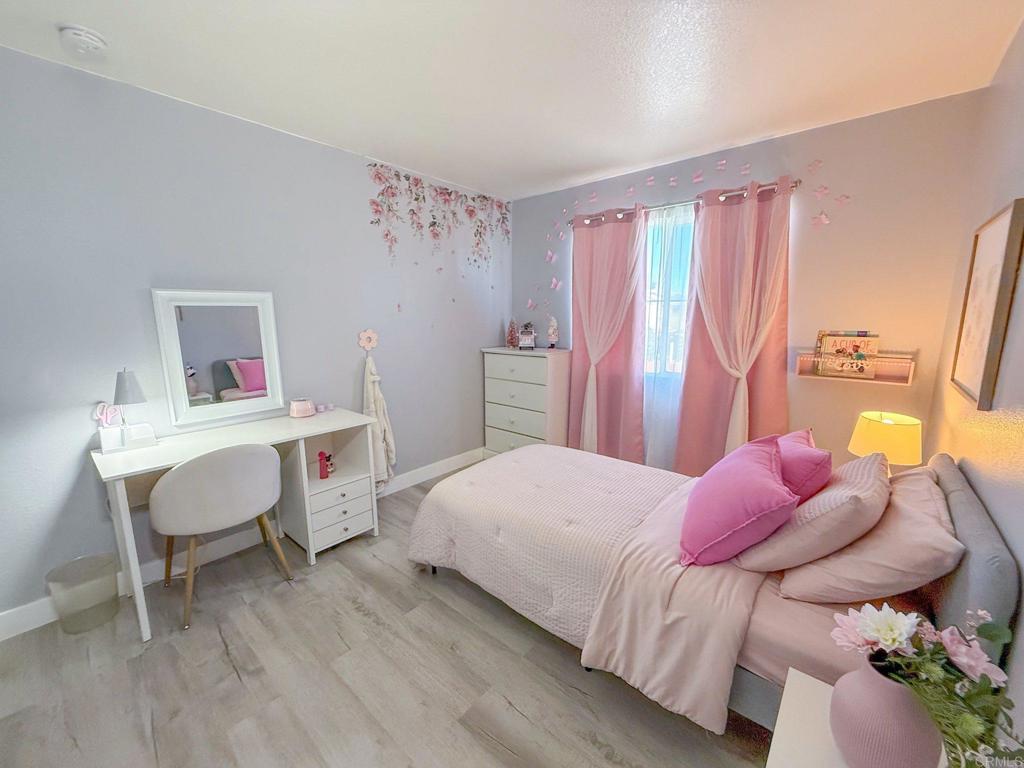 3237 Warley Road Hemet, CA 92545 - Photo 28 of 43 a bedroom with a bed and a table in it