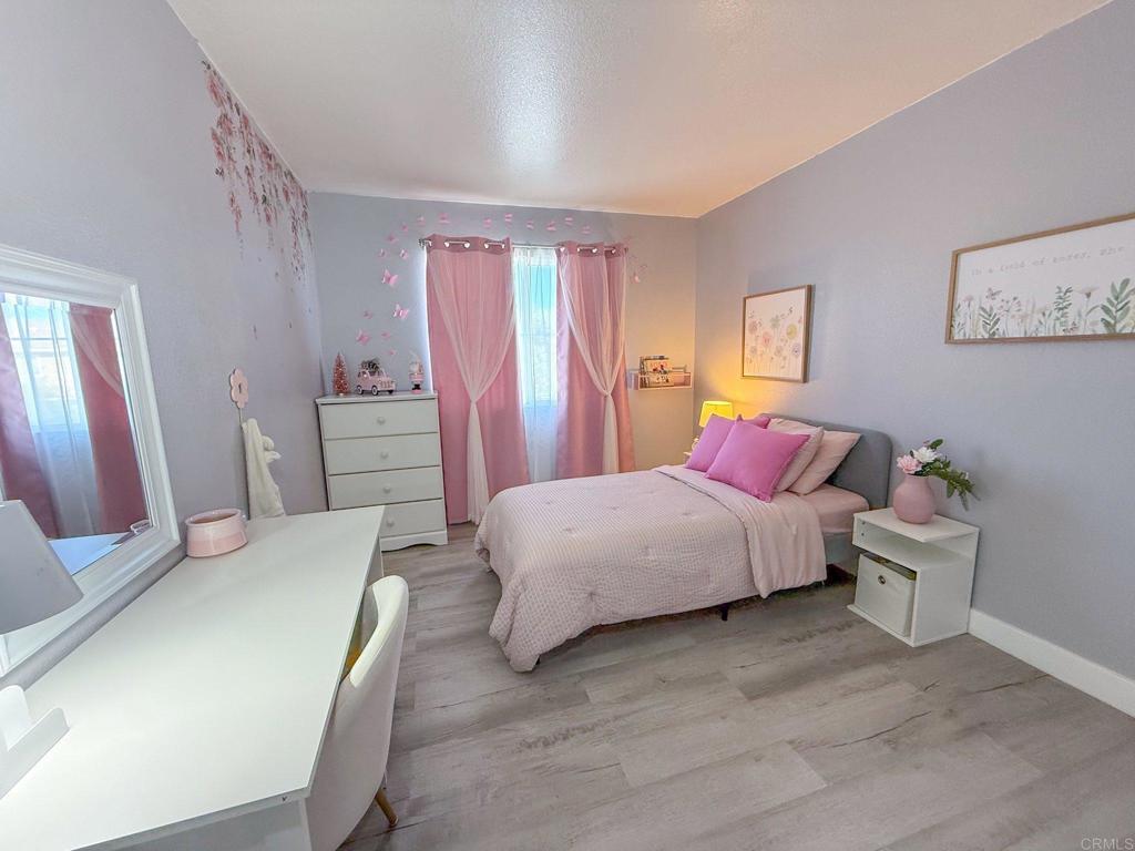 3237 Warley Road Hemet, CA 92545 - Photo 29 of 43 a bedroom with a bed and a chandelier