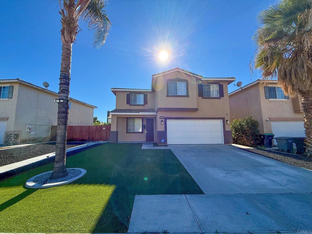 3237 Warley Road Hemet, CA 92545 - Photo 3 of 43 a front view of a house with a yard and garage