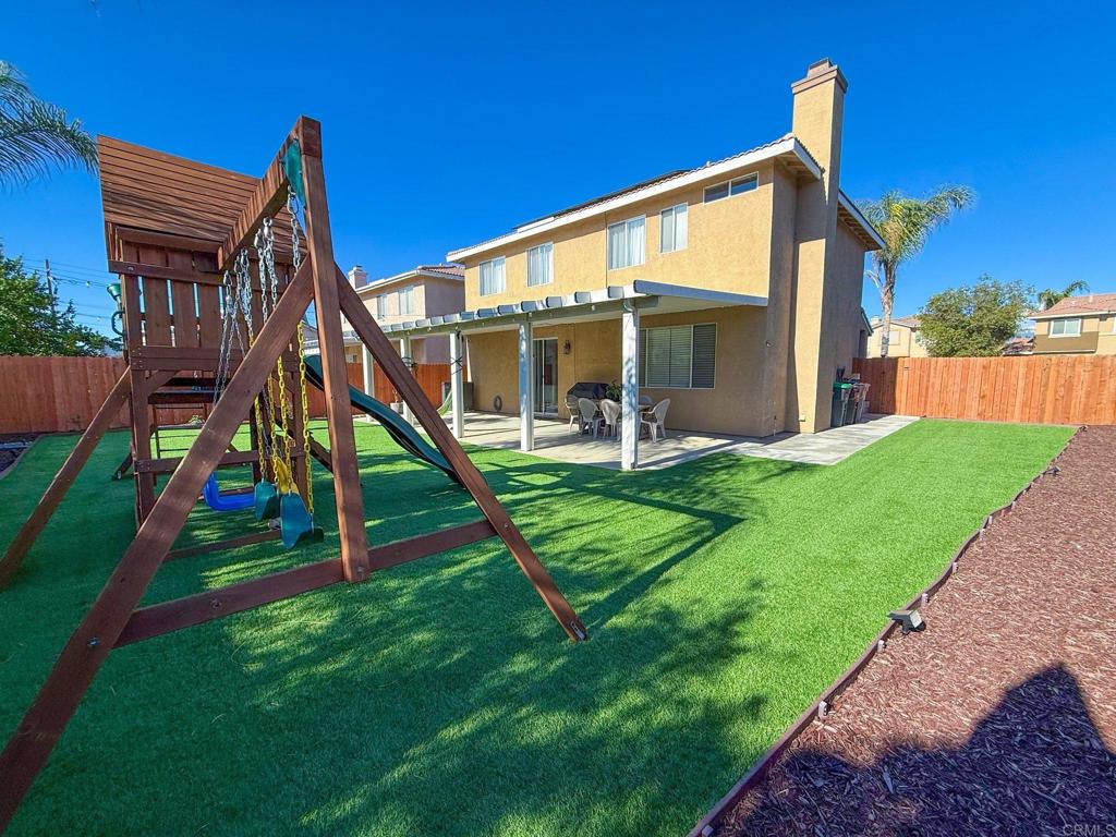 3237 Warley Road Hemet, CA 92545 - Photo 43 of 43 a view of a house with a yard and a slide