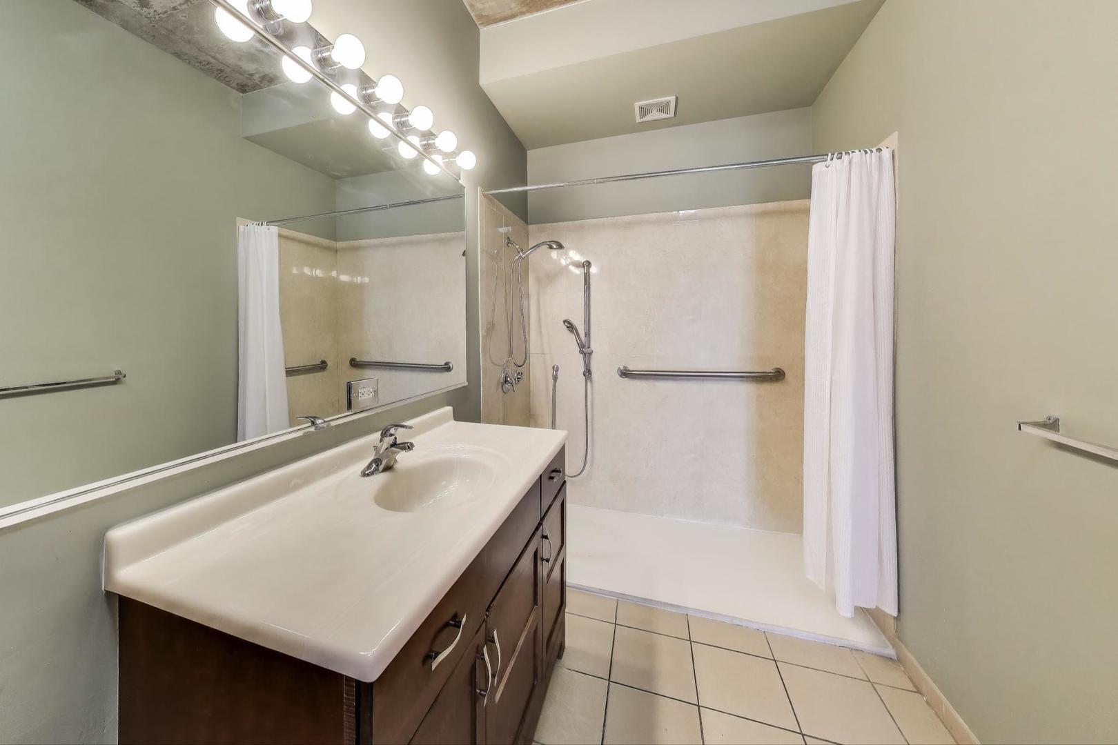 321 South Sangamon Street, Unit 605 Chicago, IL 60607 - Photo 22 of 36 a bathroom with a sink a shower and a mirror