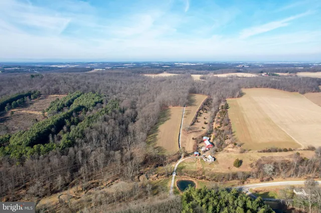 a view of a lake in middle of the field