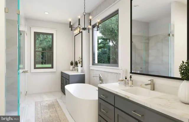 a bathroom with a double vanity sink a mirror and a bathtub