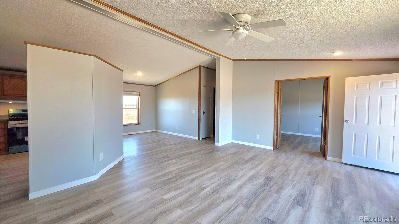 10754 County Road Olney Springs, CO 81062 - Photo 13 of 49 a view of an empty room with window and wooden floor