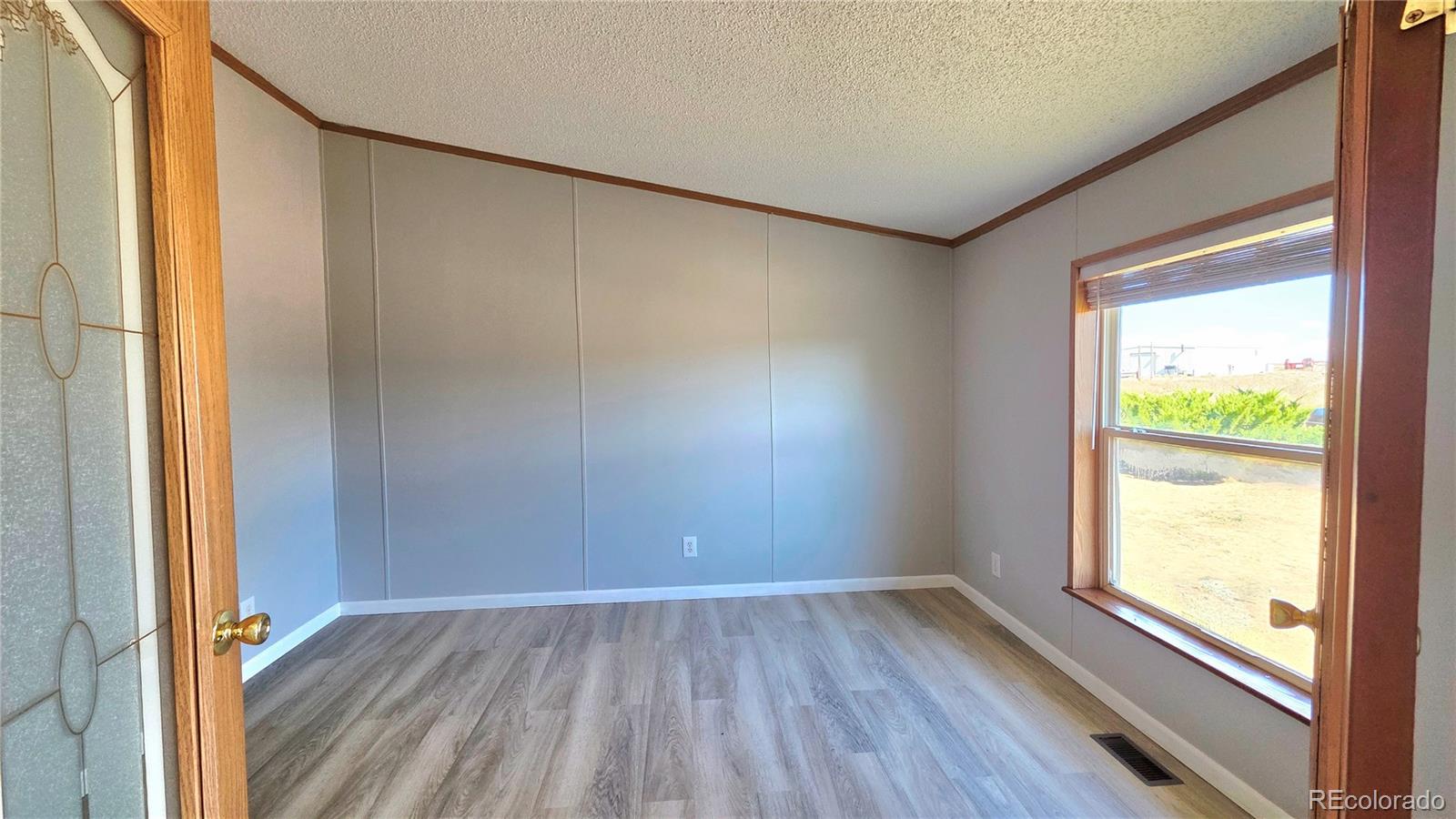 10754 County Road Olney Springs, CO 81062 - Photo 15 of 49 an empty room with wooden floor and windows