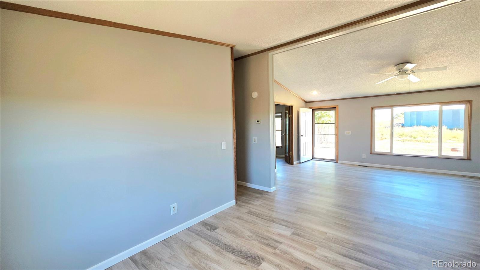 10754 County Road Olney Springs, CO 81062 - Photo 19 of 49 a view of an empty room with wooden floor and a window
