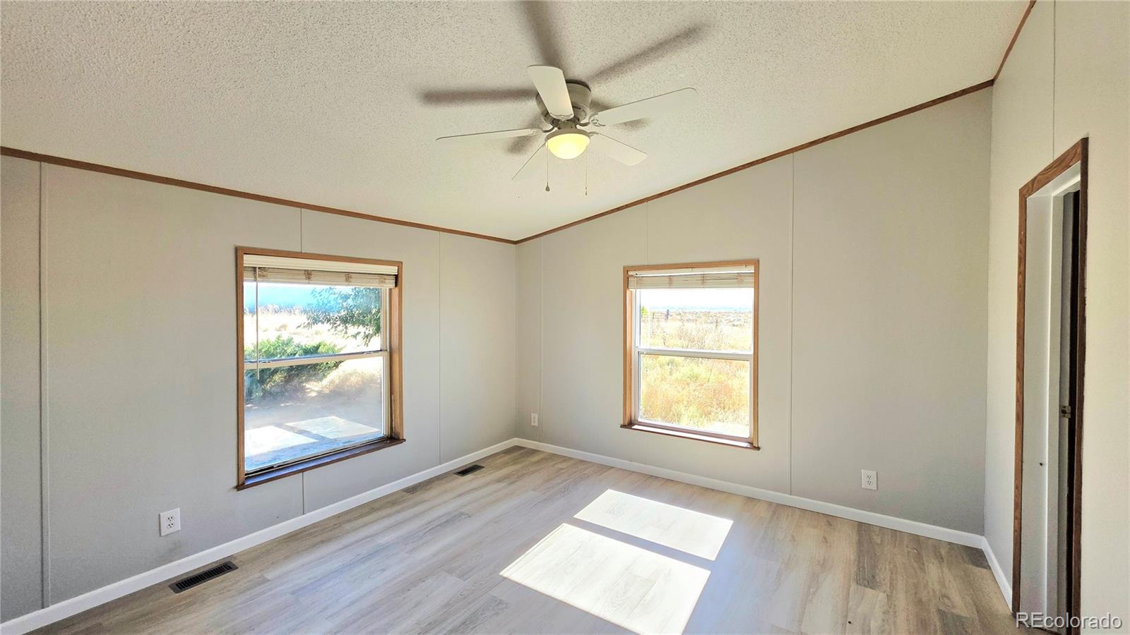 10754 County Road Olney Springs, CO 81062 - Photo 20 of 49 a view of an empty room with window and wooden floor