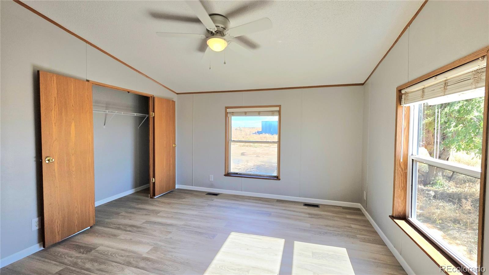 10754 County Road Olney Springs, CO 81062 - Photo 21 of 49 a view of an empty room with a window and wooden floor