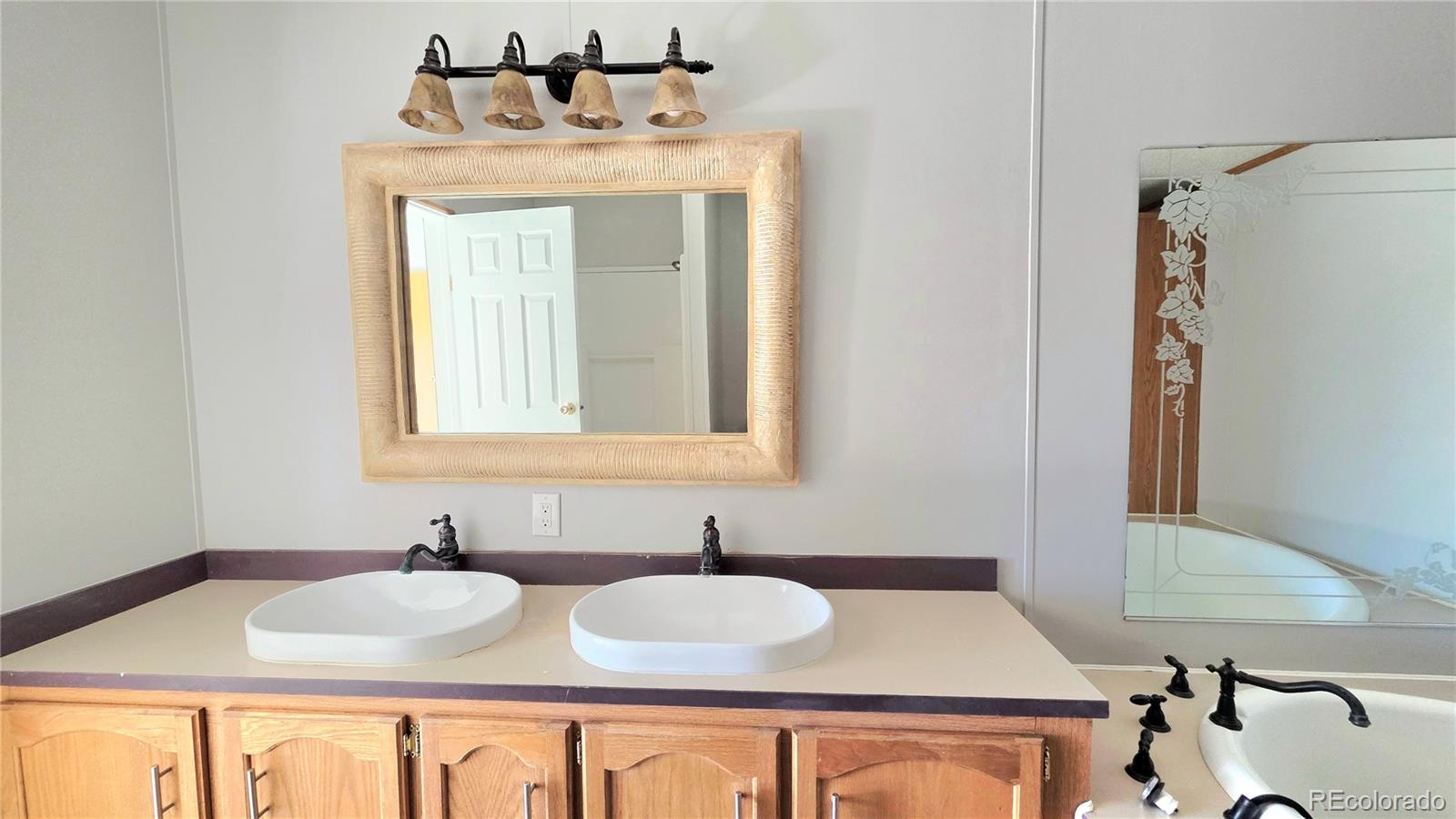 10754 County Road Olney Springs, CO 81062 - Photo 25 of 49 a bathroom with a sink and a mirror