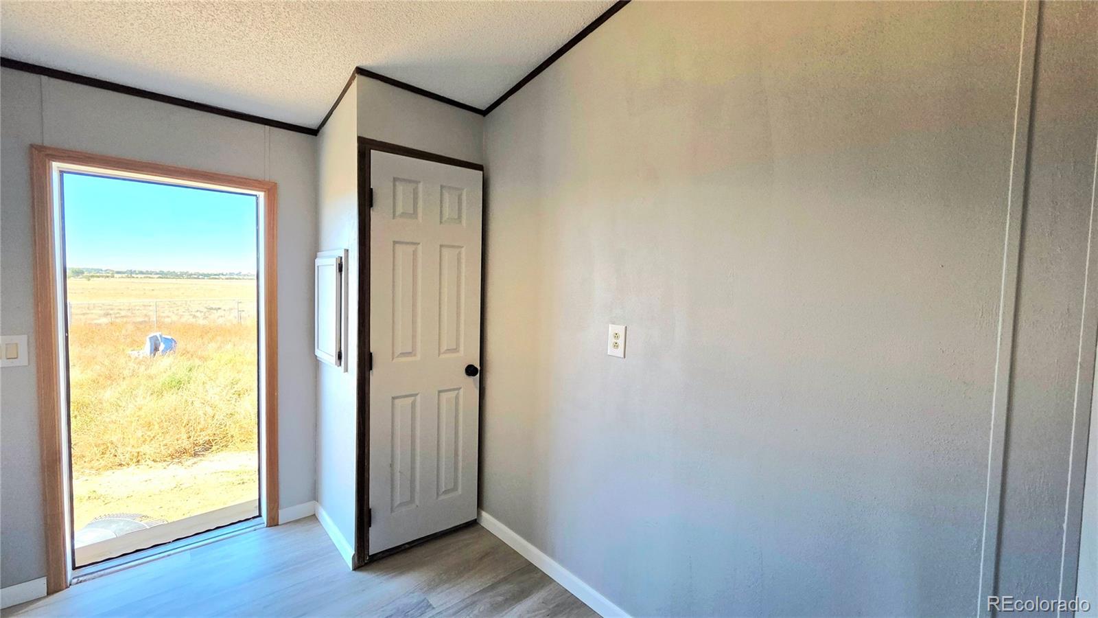 10754 County Road Olney Springs, CO 81062 - Photo 27 of 49 an empty room with wooden floor and a window