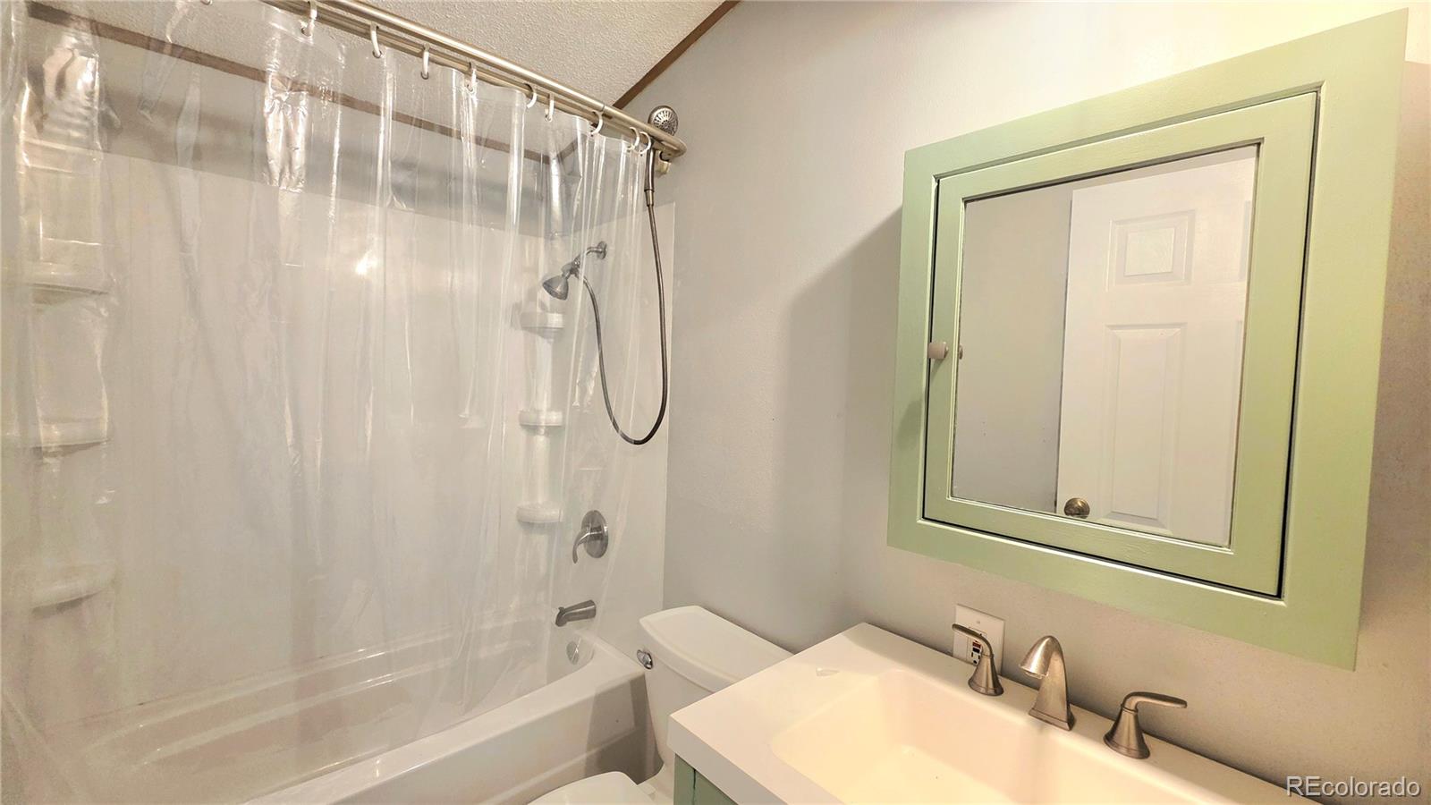 10754 County Road Olney Springs, CO 81062 - Photo 31 of 49 a bathroom with a granite countertop sink toilet and shower