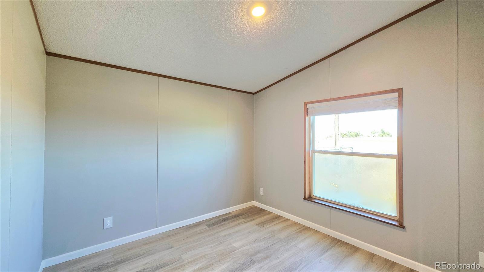 10754 County Road Olney Springs, CO 81062 - Photo 33 of 49 an empty room with wooden floor and windows